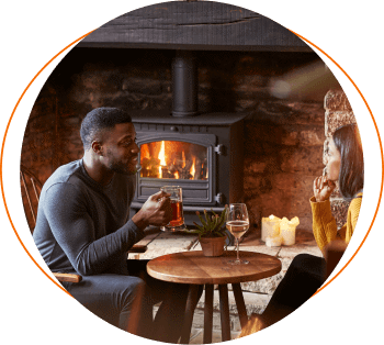 Couple in a pub drinking by a fire